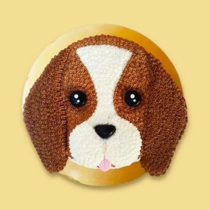 A round cake designed to look like a realistic beagle’s face with brown ears, white snout, and textured fur pattern.