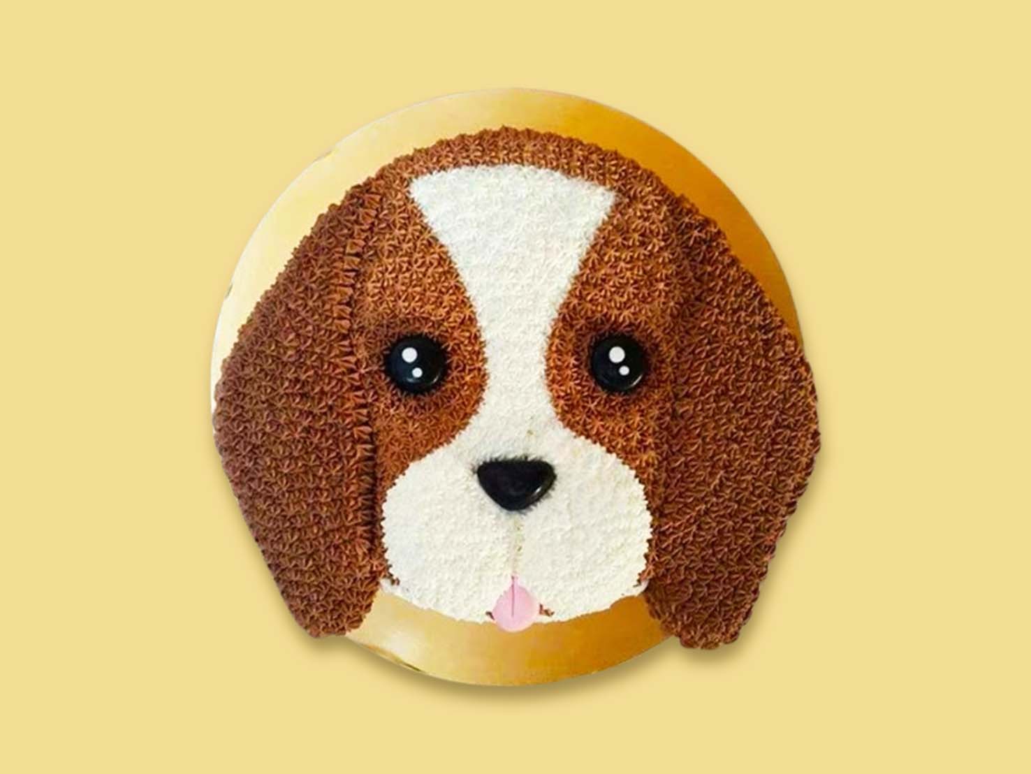 A round cake designed to look like a realistic beagle’s face with brown ears, white snout, and textured fur pattern.