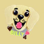 Cake shaped like a happy yellow Labrador dog with creamy big eyes and tongue out.