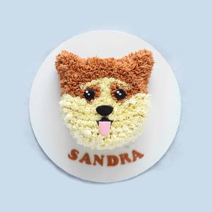 Realistic corgi-shaped dog birthday cake with creamy fur texture and cute eyes, placed on a white base.