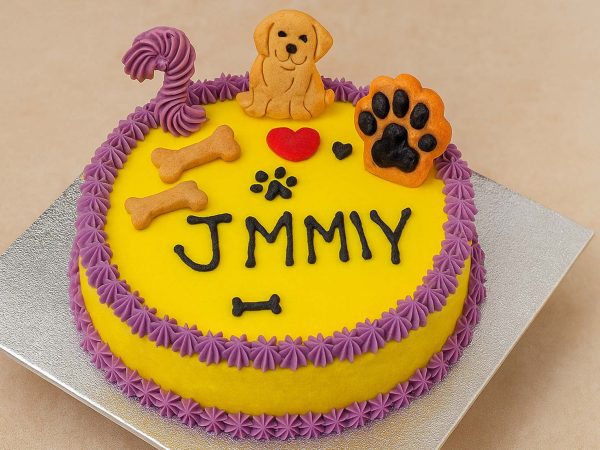 Yellow round birthday dog cake with toy decorations