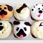 Box of six themed dog cupcakes with paw, bone, and dog face decorations.