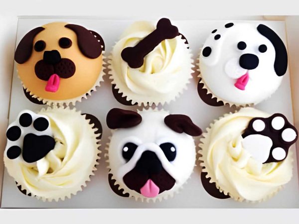 Box of six themed dog cupcakes with paw, bone, and dog face decorations.