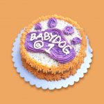 Double-layer orange and white paw cake with purple icing.