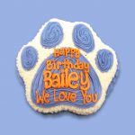 Blue and white paw birthday cake in paw shape with custom text on top