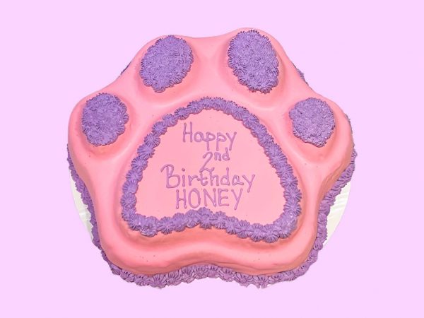 Pink and purple paw cake in paw shape with custom text on top