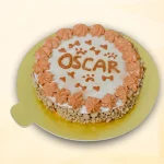 Round dog cake with white frosting, peach cream border, and cute designs