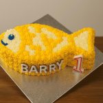 Fish-shaped yellow cat birthday cake